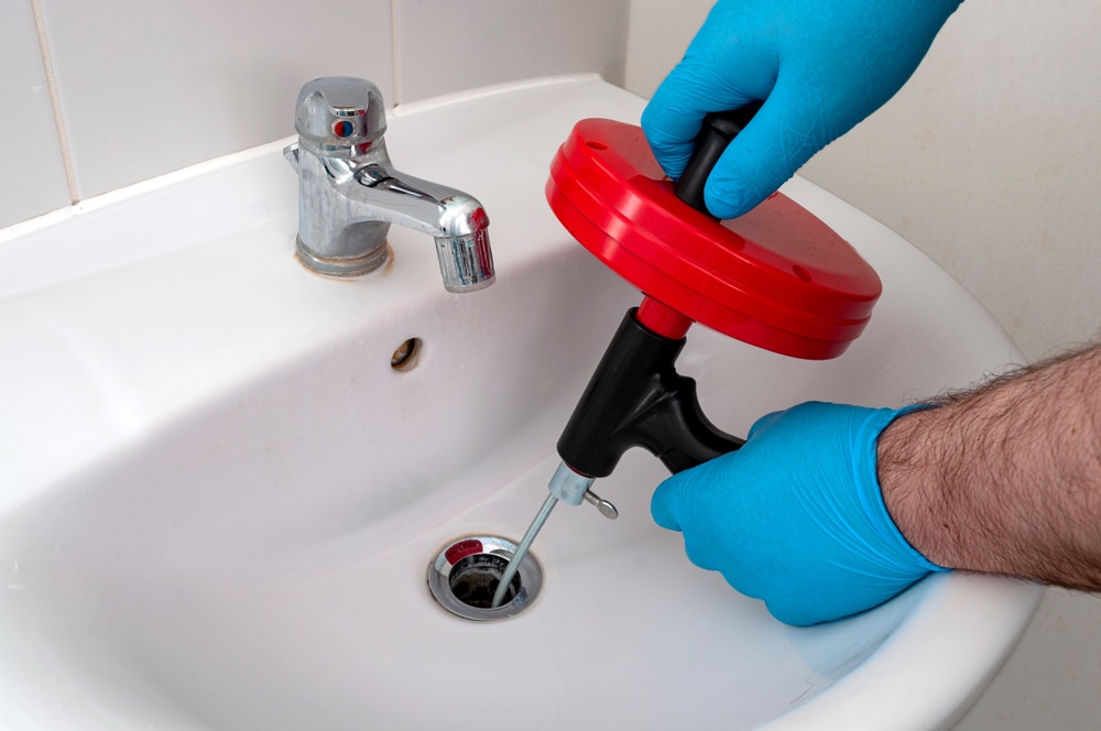 drain snake, plumbing, blockages, clogged drains, types of drain snakes, choosing the right drain snake, step-by-step guide, maintenance tips, common mistakes, professional plumber